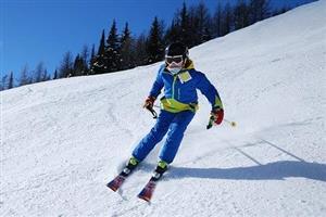 A person skiing with blue skies